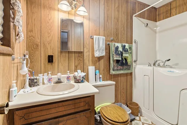 a bathroom with a sink a toilet and shower