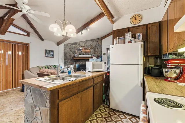 a utility room with dryer washer and a view of living room
