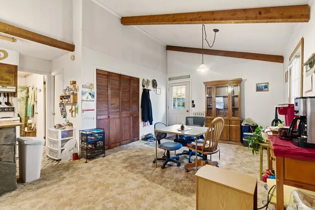 a view of a livingroom with workspace and a window