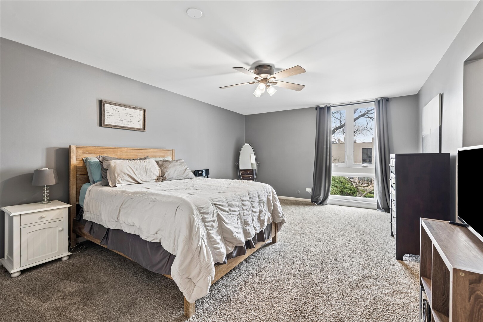 20 Oak Tree Court, Unit 20 Elmhurst, IL 60126 - Photo 19 of 35 a spacious bedroom with a bed and a flat screen tv
