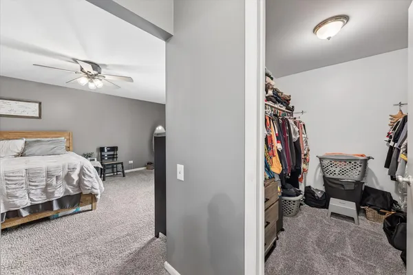 a view of a bedroom with a baby crib and a couch