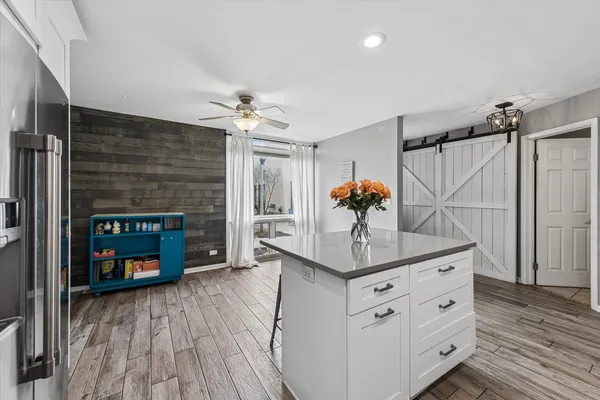 a kitchen with stainless steel appliances a sink cabinets and wooden floor