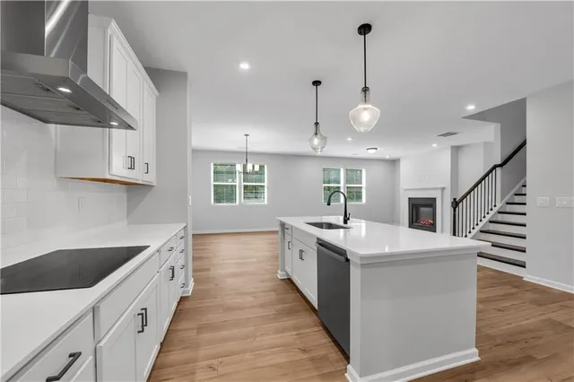 a kitchen with stainless steel appliances granite countertop a sink and cabinets