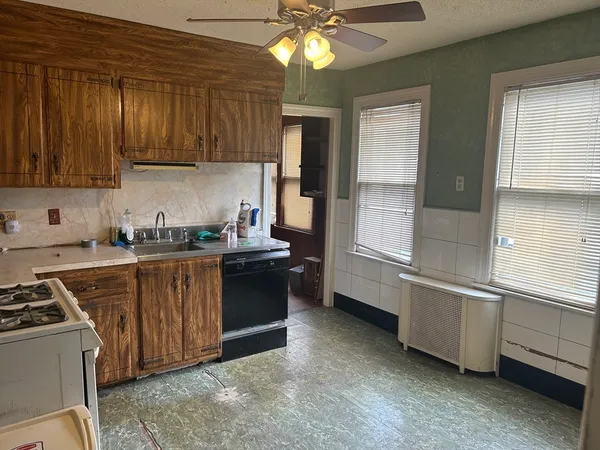 a kitchen with stainless steel appliances granite countertop a stove a sink and a refrigerator