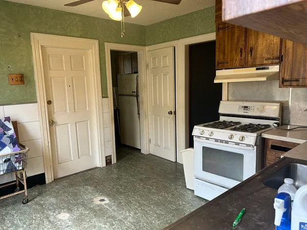a kitchen with a stove and a refrigerator
