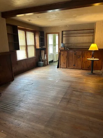 a view of empty room with a fireplace