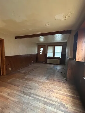 a view of a room with a fireplace and window