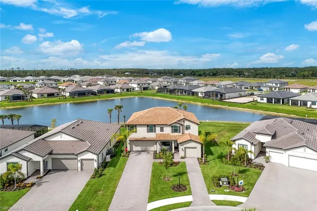 an aerial view of a house with a garden and lake view