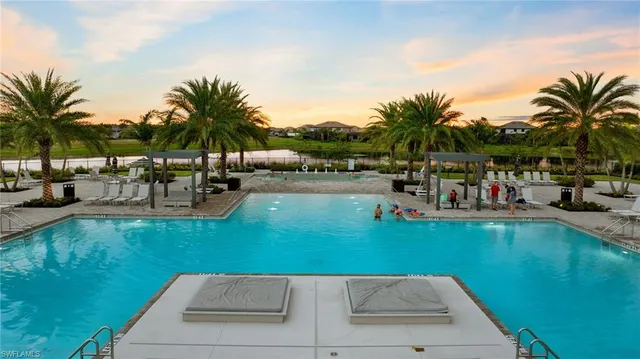 a view of a tennis ground with large trees
