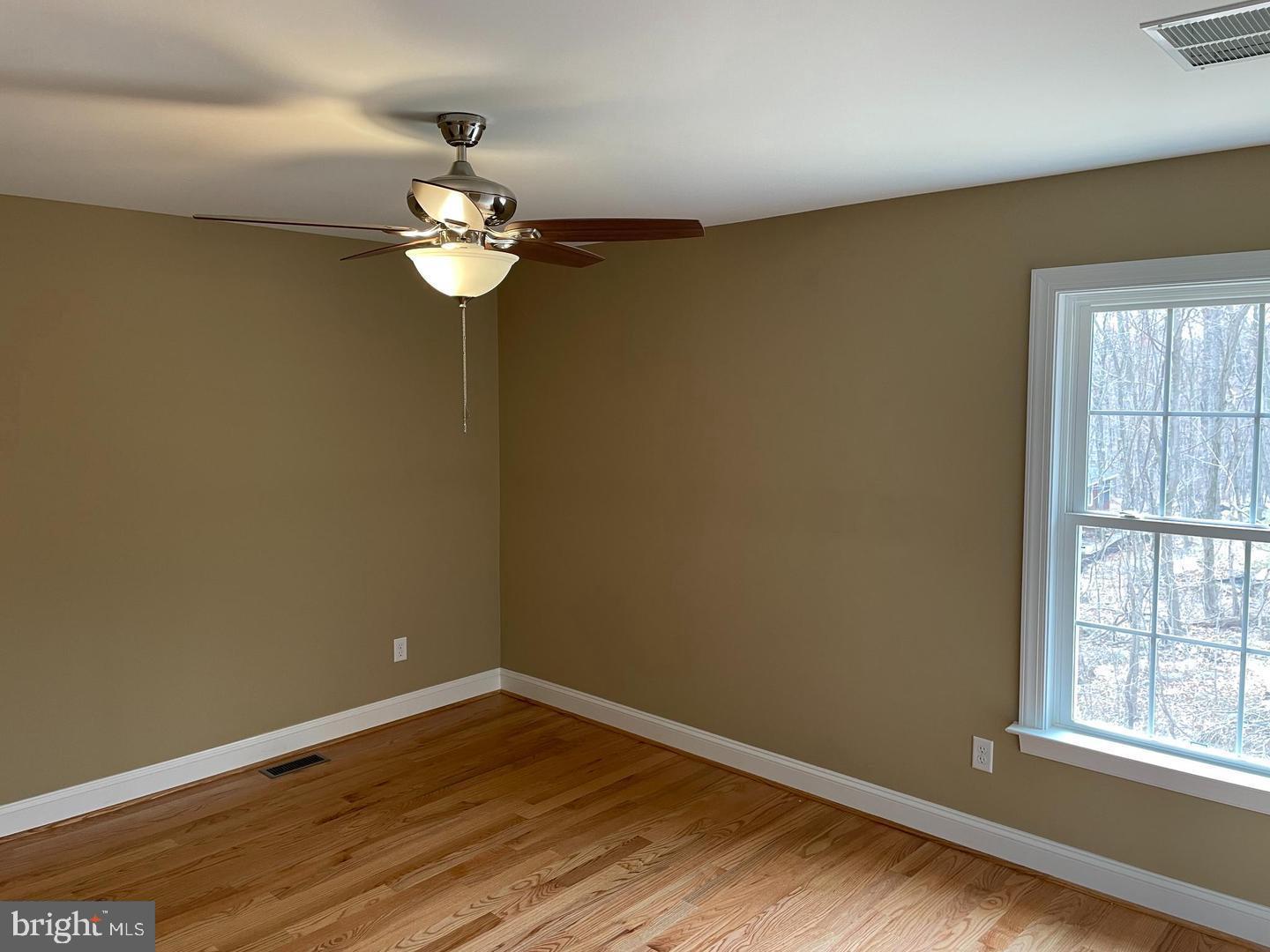 7 Comanche Trail Winchester, VA 22602 - Photo 12 of 15 a view of wooden floor and chandelier fan in a room