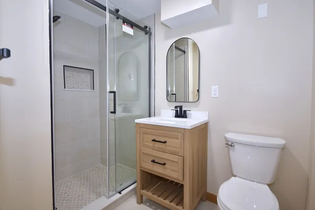 a bathroom with a toilet sink and shower