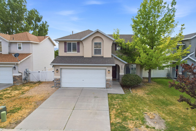 5485 Heather Way Tooele, UT 84074 - Photo 5 of 41 Two-story residence featuring a two-car garage, stone accents, and a concrete driveway