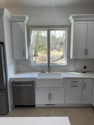 a kitchen with a sink stove and cabinets