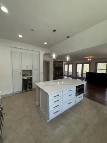 a large kitchen with stainless steel appliances a large counter top
