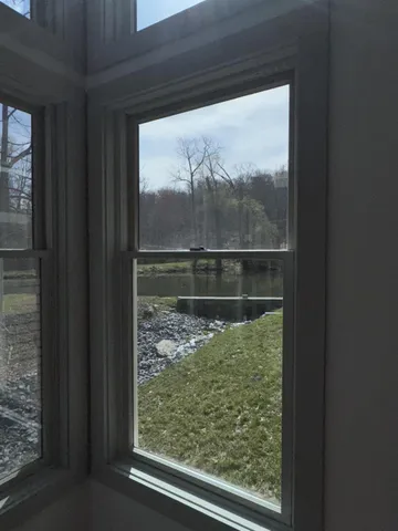 a room with wooden floor and windows