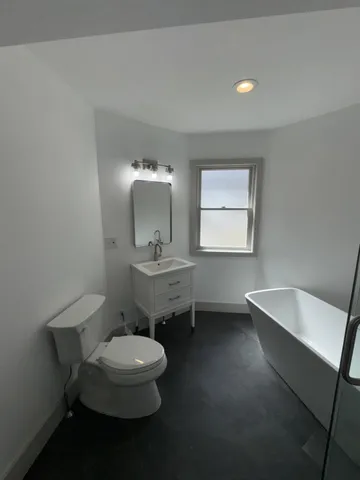 a view of a livingroom with wooden floor and a window