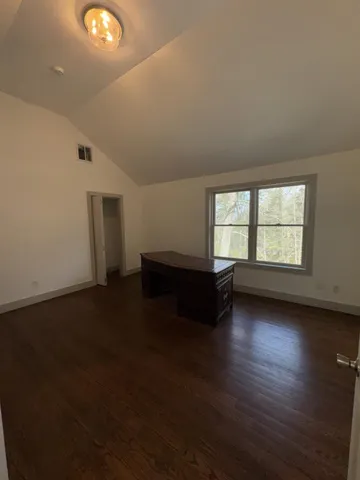 a large white kitchen with a stove a sink a refrigerator and a fireplace