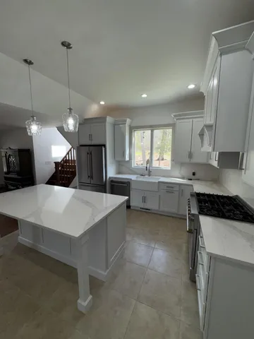 a view of empty room with wooden floor and door