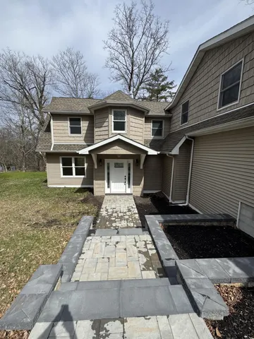 a front view of a house with a yard