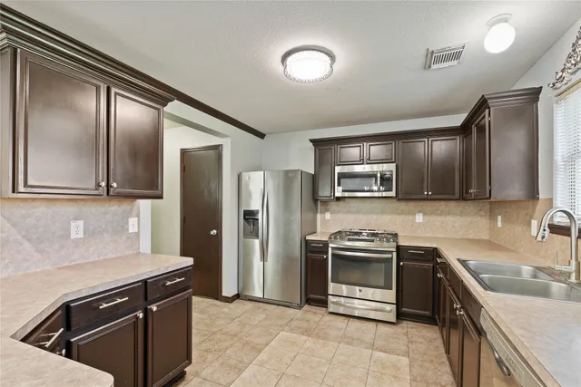a view of a hallway with wooden floor and entryway