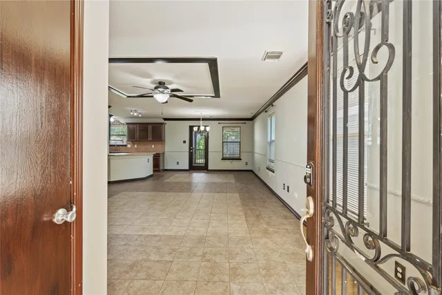 a view of a livingroom with an entryway and kitchen view