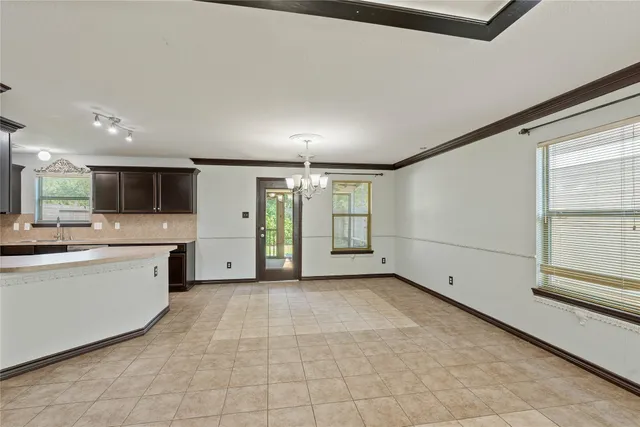 a large kitchen with stainless steel appliances kitchen island granite countertop a sink and cabinets