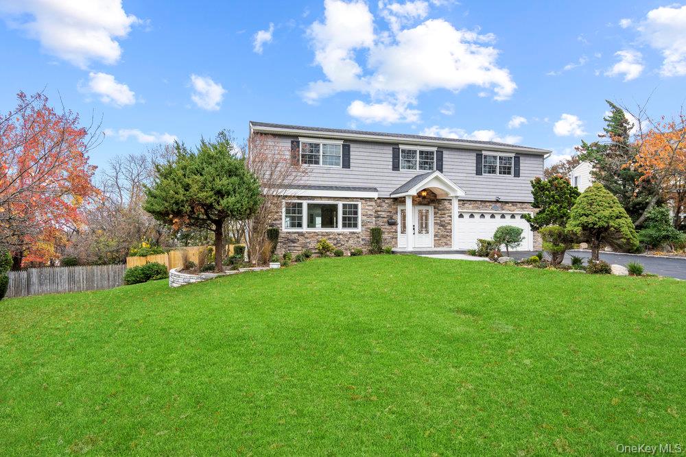 a front view of a house with a garden