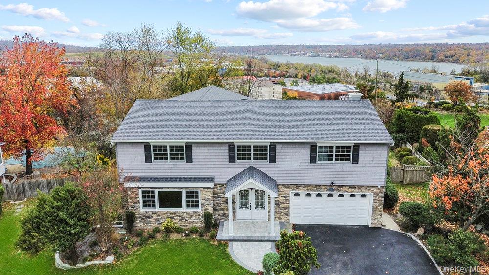 52 Woodland Road Roslyn, NY 11576 - Photo 16 of 23 a front view of a house with a yard
