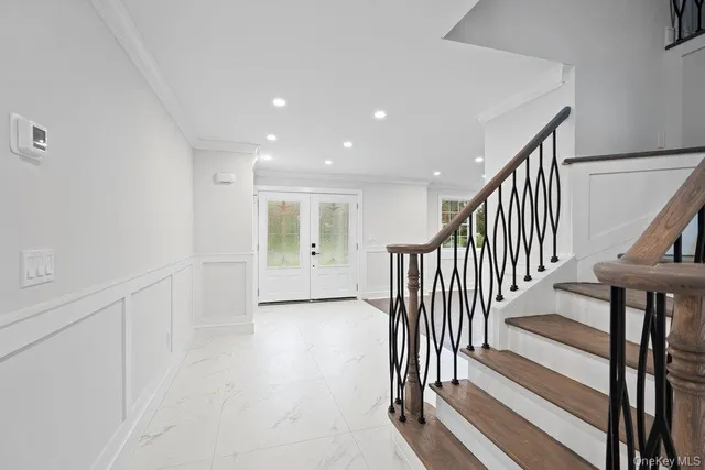 a view of a hallway with wooden floor and staircase