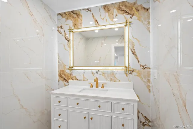a bathroom with a sink and mirror with vanity