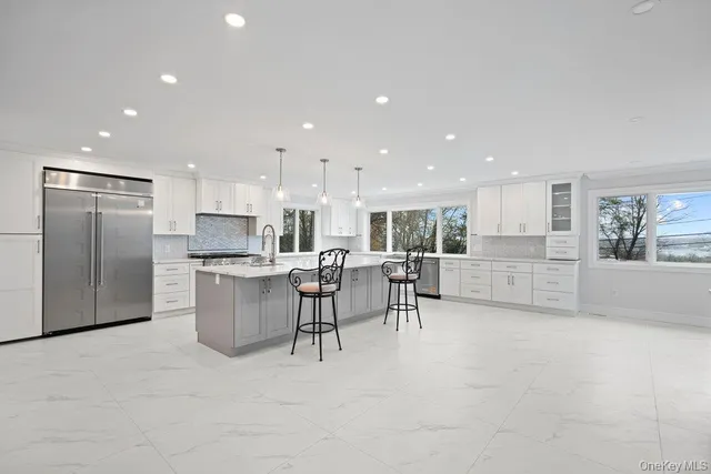 a view of kitchen with refrigerator and microwave