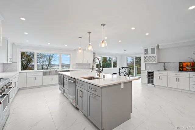 a kitchen with stainless steel appliances kitchen island granite countertop a sink and cabinets
