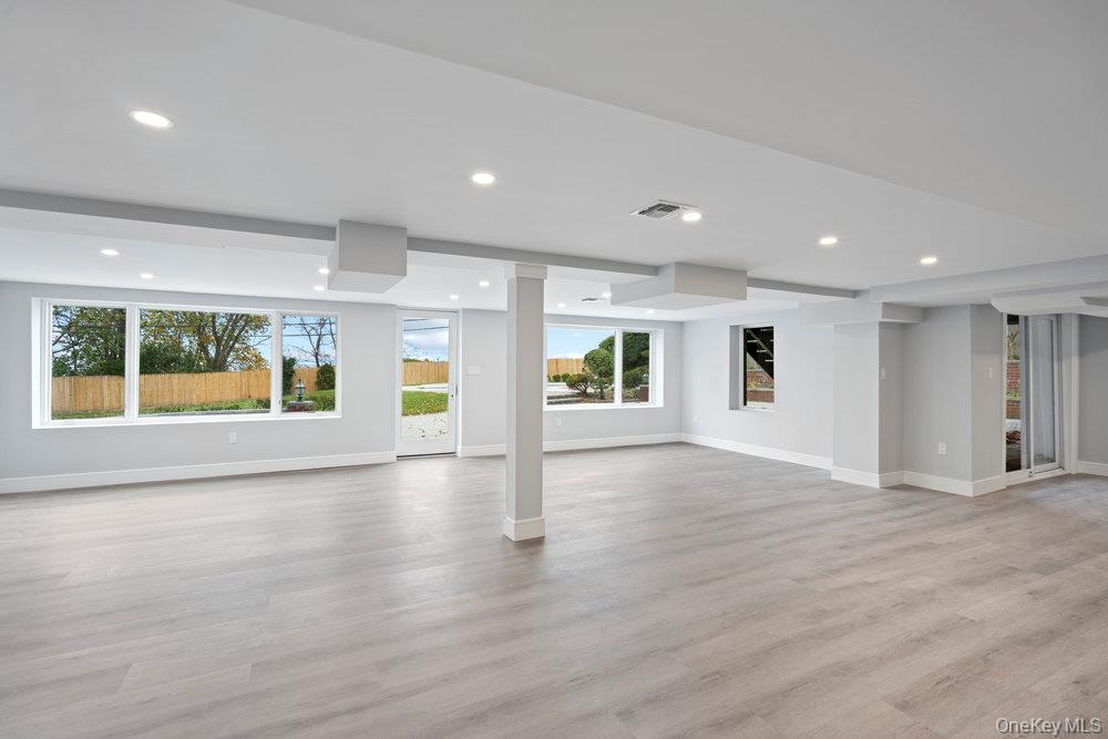 52 Woodland Road Roslyn, NY 11576 - Photo 9 of 23 an empty room with window and wooden floor