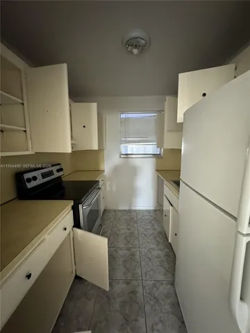 a kitchen with a refrigerator and a stove