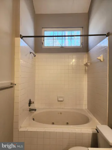 a bathroom with a shower and a bath tub