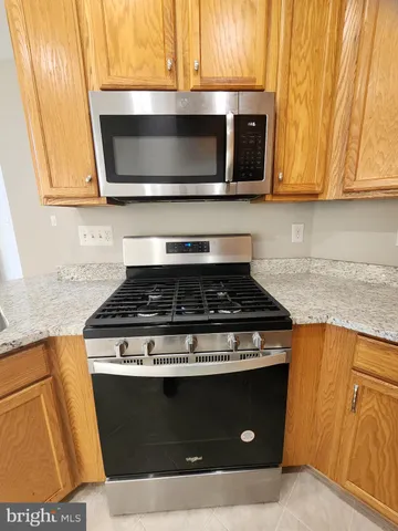 a stove top oven sitting inside of a kitchen