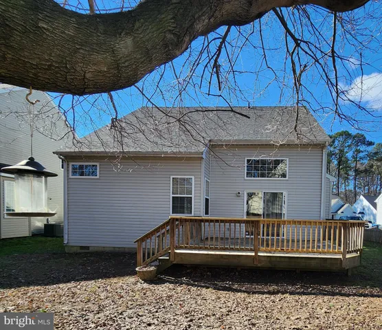 a view of a house with a wooden deck