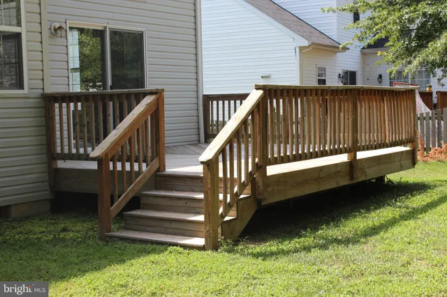 a view of backyard with deck and garden
