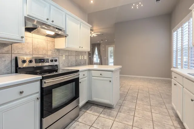 a kitchen with a stove cabinets and a sink