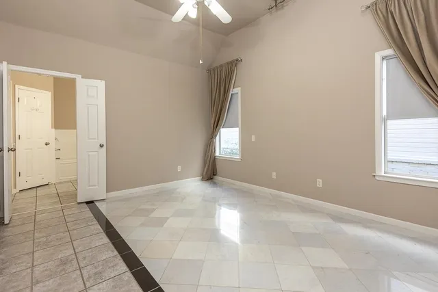 an empty room with windows and entrance