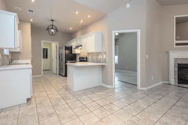 a view of kitchen with stainless steel appliances cabinets and counter space