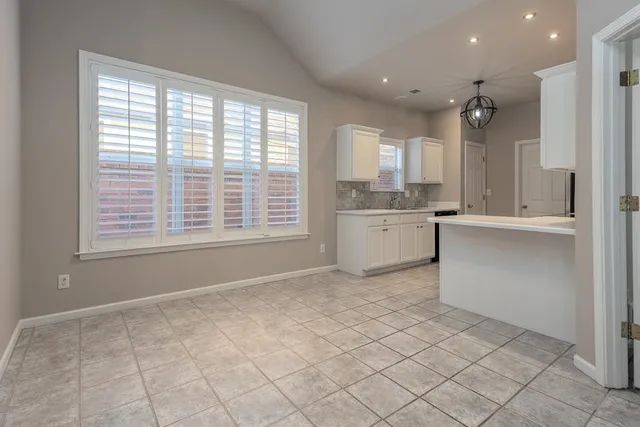 a kitchen with a stove a sink and a refrigerator
