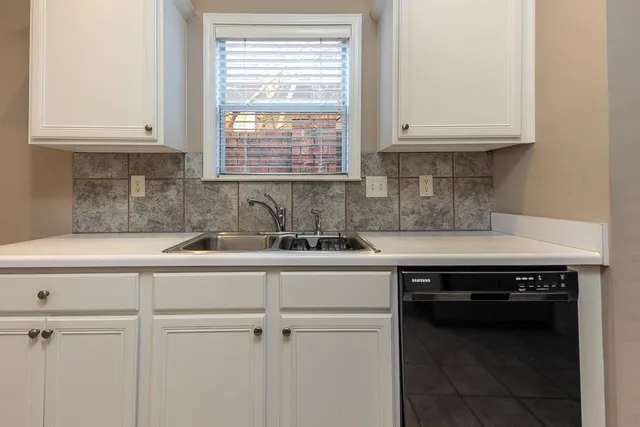 a kitchen with a sink cabinets and window