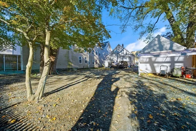 a view of a yard with wooden fence