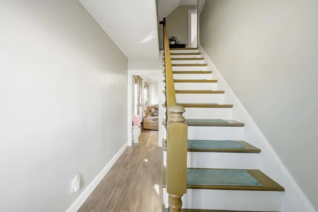 a view of entryway and hall with wooden floor