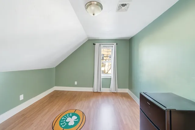 a view of a room with window and wooden floor