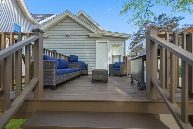 a view of a house with a large window and wooden fence