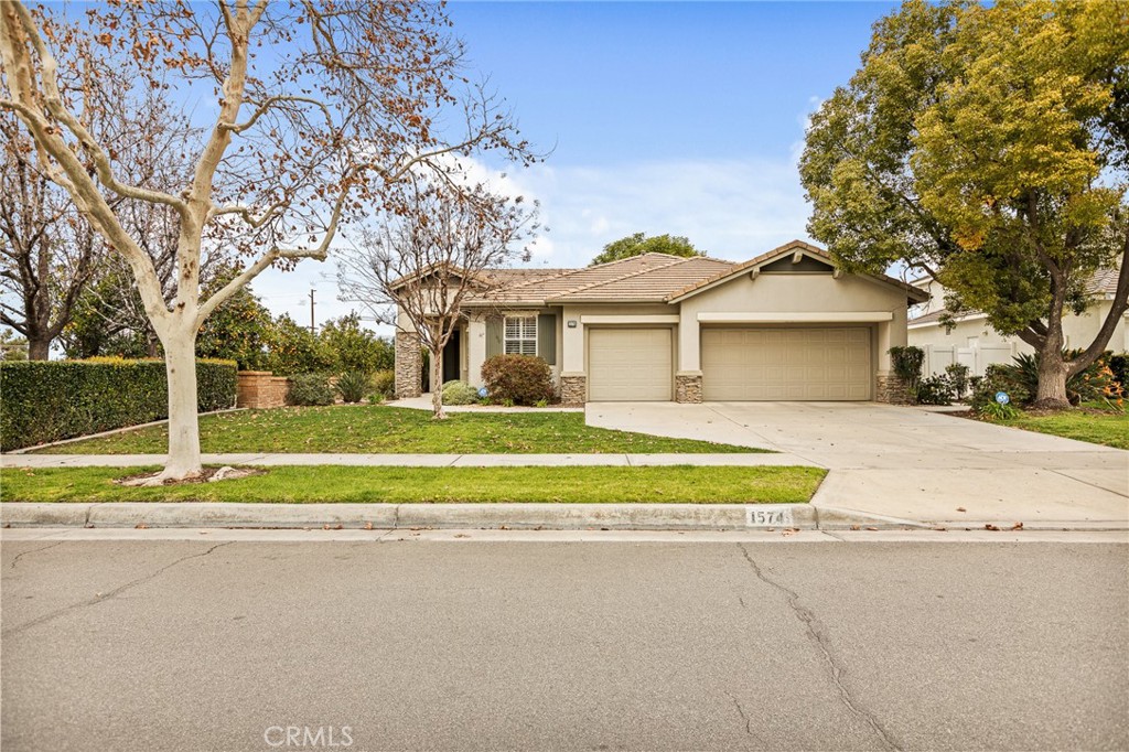 1574 Foothill Way Redlands, CA 92374 - Photo 1 of 1 a house with trees in the background