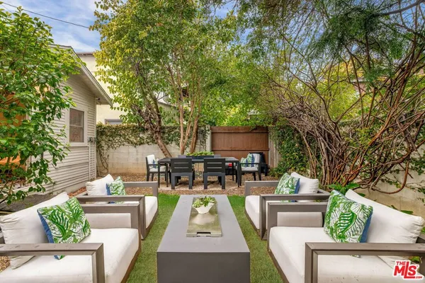 a view of backyard with seating area and green space