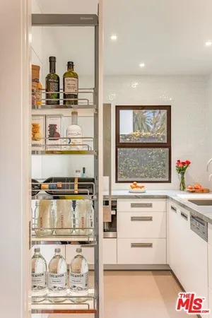 a kitchen with a sink and a stove next to a window